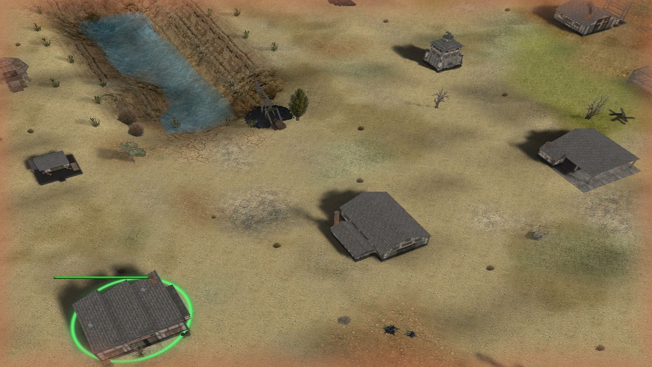 Base buildings spread over dry ground beside a small lake, one of them selected with a green ring.